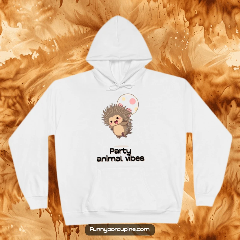 Funny hoodie depicting a cute porcupine gleefully bouncing on a huge polka-dot balloon, radiating pure happiness.