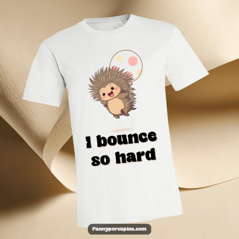 Funny t-shirt displaying a cute porcupine joyfully bouncing on a giant, polka-dotted balloon with a gleeful expression.